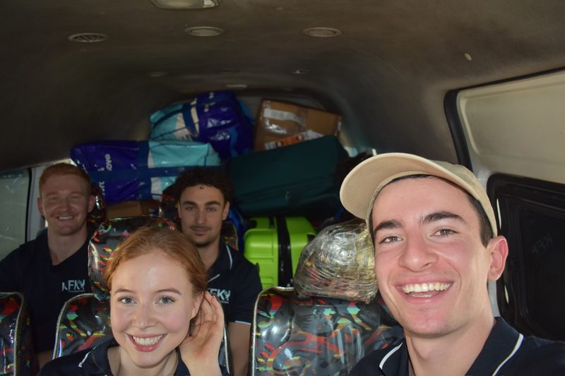 KFK team members in a van packed to the roof with bags of donated sporting equipment