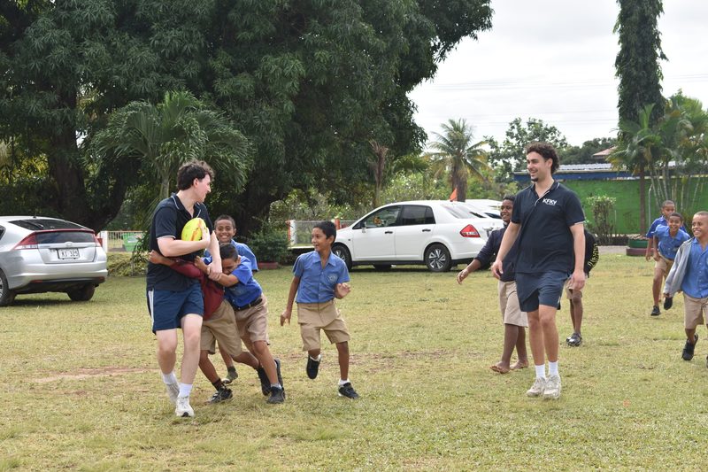 KFK volunteers playing pick-up footy with school kids in Fiji